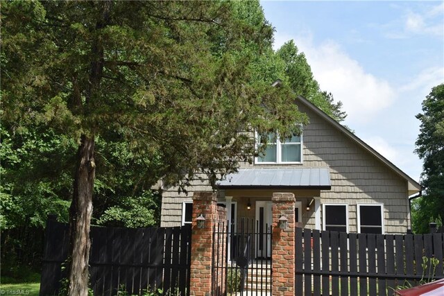 5170 Tabernacle School Rd, Asheboro, NC 27205 - view of front of house with a fenced front yard, a standing seam roof, and a metal roof