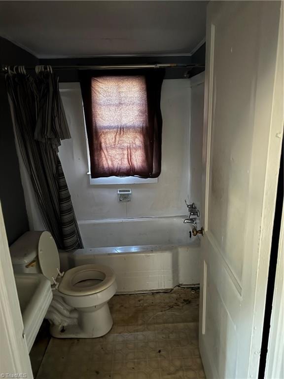 bathroom with shower / bath combination with curtain and toilet