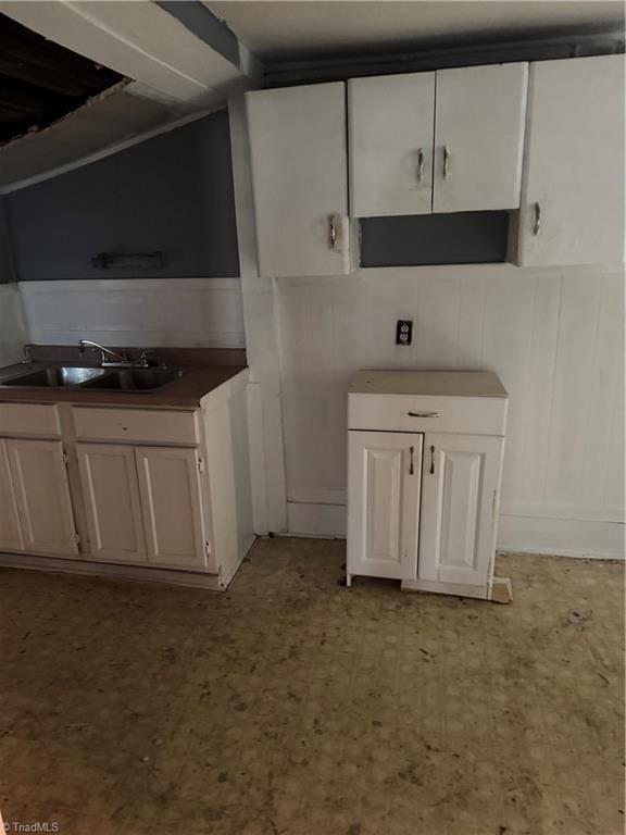 kitchen with sink and white cabinetry