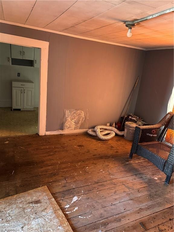 sitting room with hardwood / wood-style floors and ornamental molding