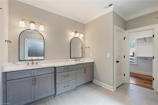 full bathroom with visible vents, crown molding, and a sink