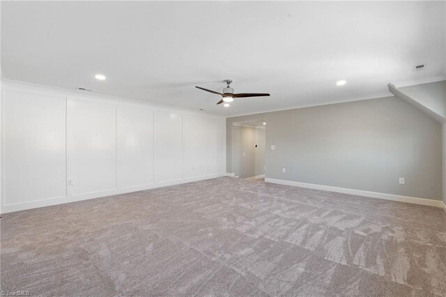 carpeted spare room with ceiling fan, recessed lighting, visible vents, and ornamental molding