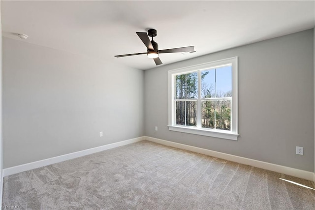 unfurnished room featuring baseboards, carpet floors, and ceiling fan