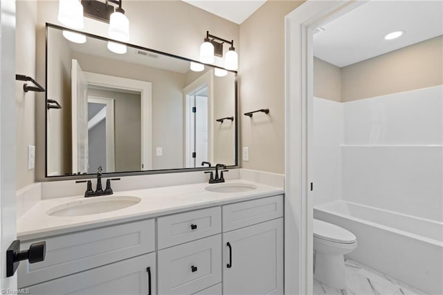 full bathroom with a sink, toilet, marble finish floor, and double vanity