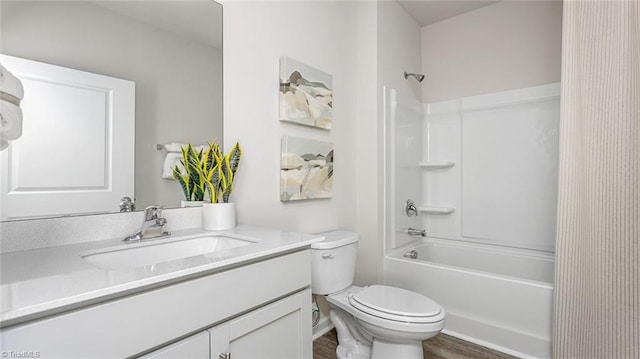 bathroom featuring toilet, vanity, and washtub / shower combination