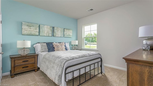 bedroom with light colored carpet, visible vents, and baseboards