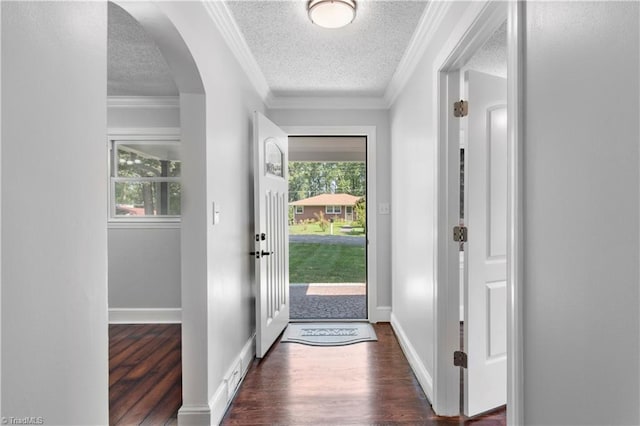 doorway to outside featuring dark wood-style floors, ornamental molding, and a wealth of natural light