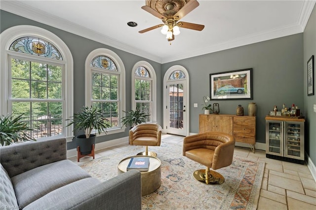 living area featuring plenty of natural light, crown molding, tile patterned flooring, and ceiling fan