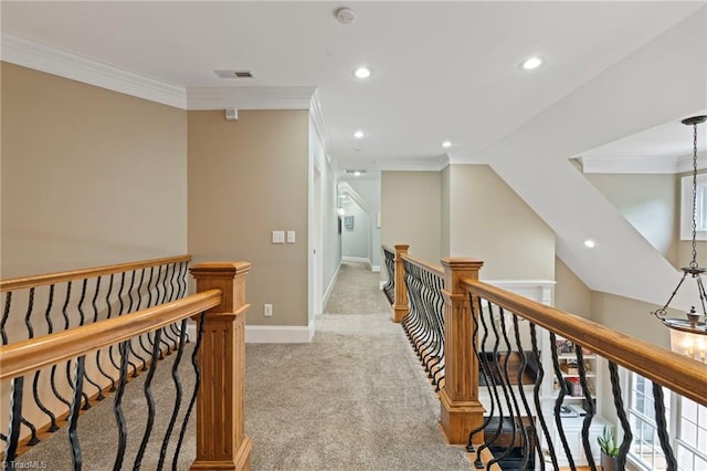 hallway featuring carpet flooring and crown molding