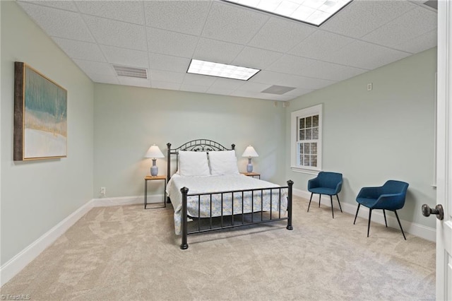 carpeted bedroom featuring a paneled ceiling