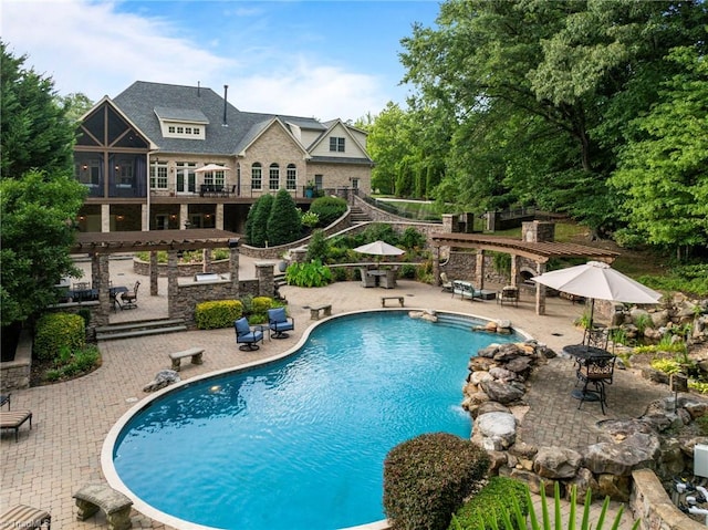 view of pool featuring a patio area and a pergola