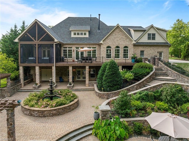 back of house with a balcony and a patio area