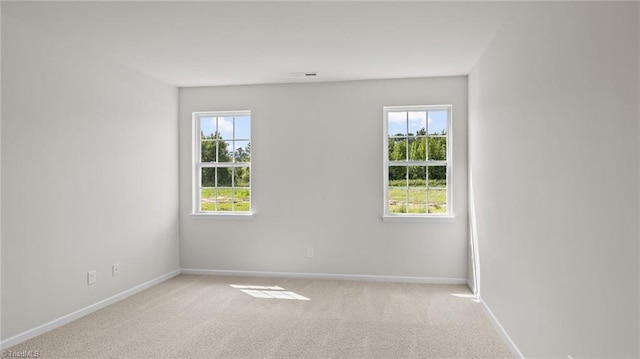 carpeted spare room with baseboards