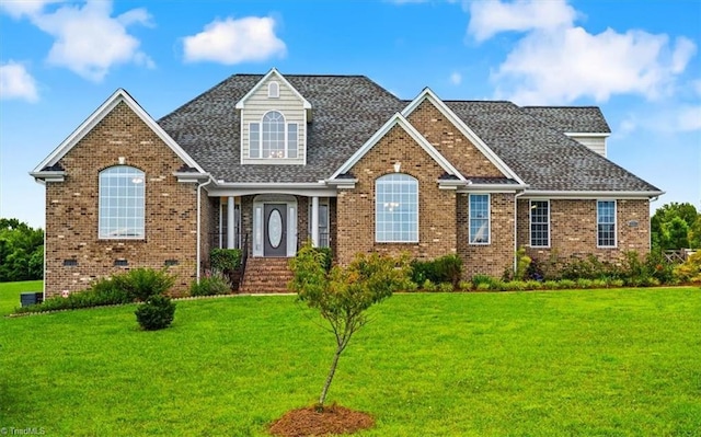 7103 Ludgate Rd, Gibsonville, NC 27249 - view of front of property with a front yard and brick siding