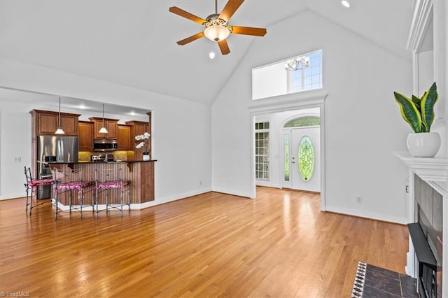 7103 Ludgate Rd, Gibsonville, NC 27249 - living area featuring high vaulted ceiling, ceiling fan, light wood-type flooring, recessed lighting, and a fireplace with flush hearth