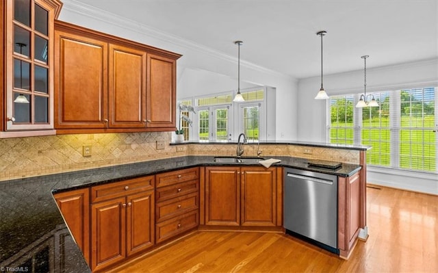 7103 Ludgate Rd, Gibsonville, NC 27249 - kitchen with dishwasher, light wood-type flooring, pendant lighting, brown cabinetry, and ornamental molding