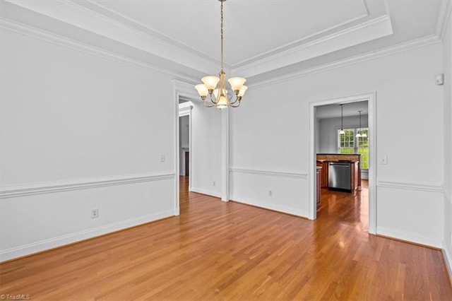 7103 Ludgate Rd, Gibsonville, NC 27249 - unfurnished room with a chandelier, light wood finished floors, a raised ceiling, and crown molding