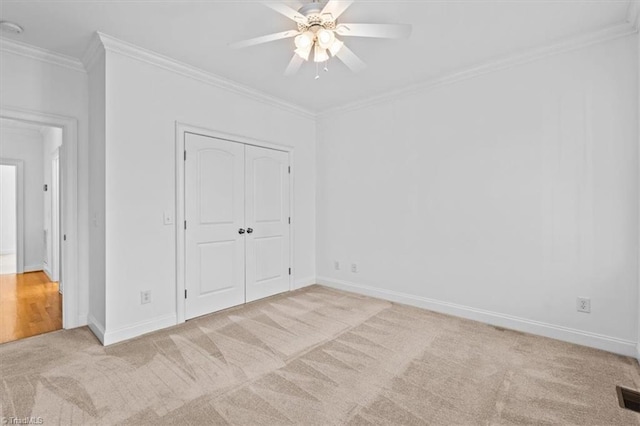 7103 Ludgate Rd, Gibsonville, NC 27249 - unfurnished bedroom with carpet, ornamental molding, a closet, and a ceiling fan