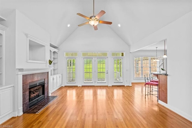 7103 Ludgate Rd, Gibsonville, NC 27249 - living room with a fireplace, a ceiling fan, wood finished floors, high vaulted ceiling, and built in shelves