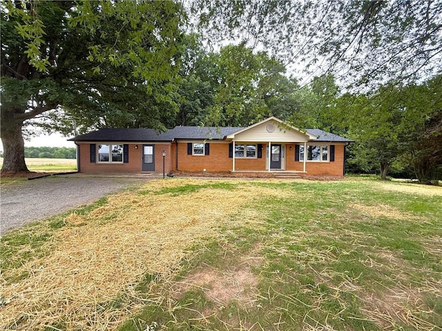 856 Haynes Rd, Elkin, NC 28621 - ranch-style home featuring brick siding, a front yard, and gravel driveway