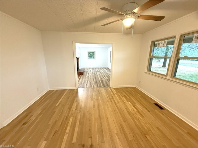 856 Haynes Rd, Elkin, NC 28621 - unfurnished room featuring wood finished floors, ornamental molding, a ceiling fan, and baseboards