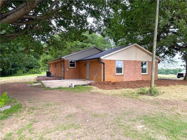 856 Haynes Rd, Elkin, NC 28621 - view of front of house featuring brick siding, a patio area, central air condition unit, and view of scattered trees