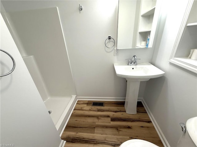 856 Haynes Rd, Elkin, NC 28621 - full bathroom with wood finished floors, a stall shower, toilet, and baseboards