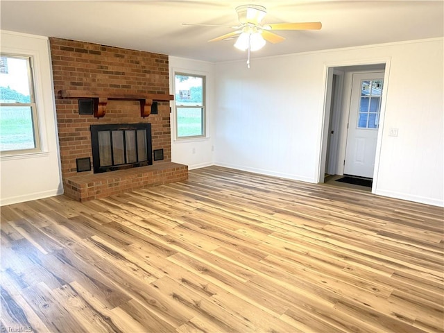 856 Haynes Rd, Elkin, NC 28621 - unfurnished living room with wood finished floors, a ceiling fan, baseboards, crown molding, and a fireplace