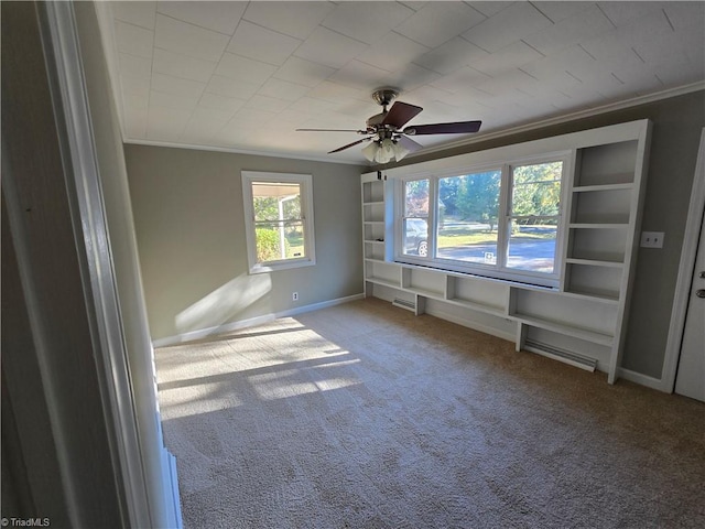 carpeted empty room featuring crown molding and ceiling fan