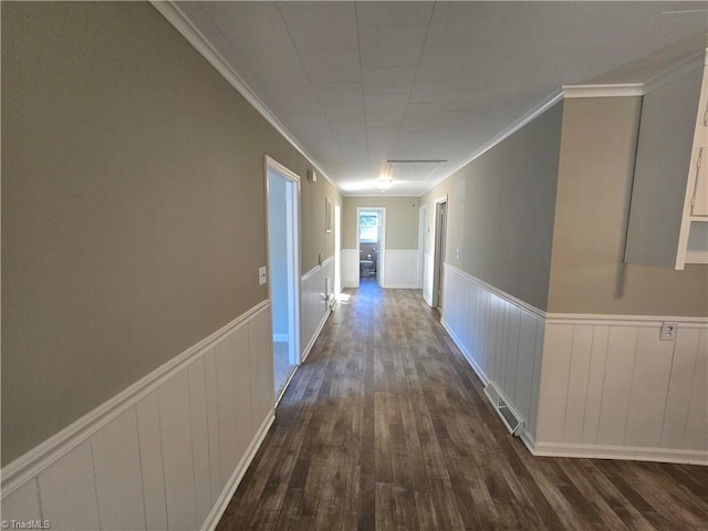 hall featuring ornamental molding and dark hardwood / wood-style floors