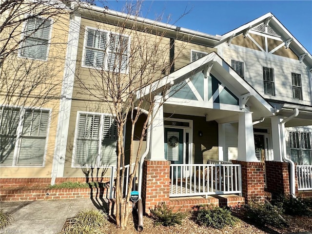 multi unit property with covered porch and brick siding