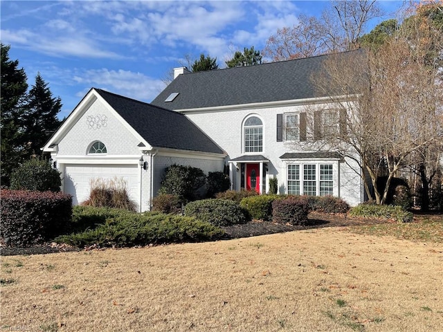 front of property featuring a garage and a front lawn