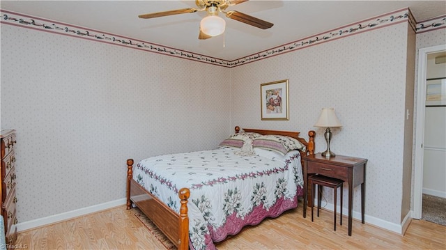 bedroom featuring hardwood / wood-style floors and ceiling fan