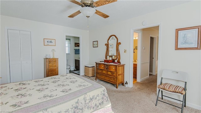 bedroom featuring ensuite bathroom, ceiling fan, light carpet, and a closet