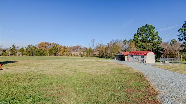 view of yard featuring a rural view and an outdoor structure