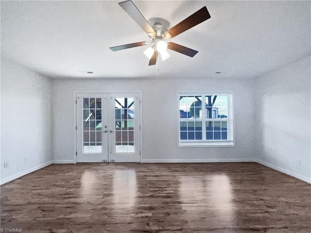 spare room featuring french doors, dark wood-type flooring, and ceiling fan