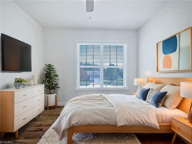 bedroom featuring dark hardwood / wood-style flooring and ceiling fan