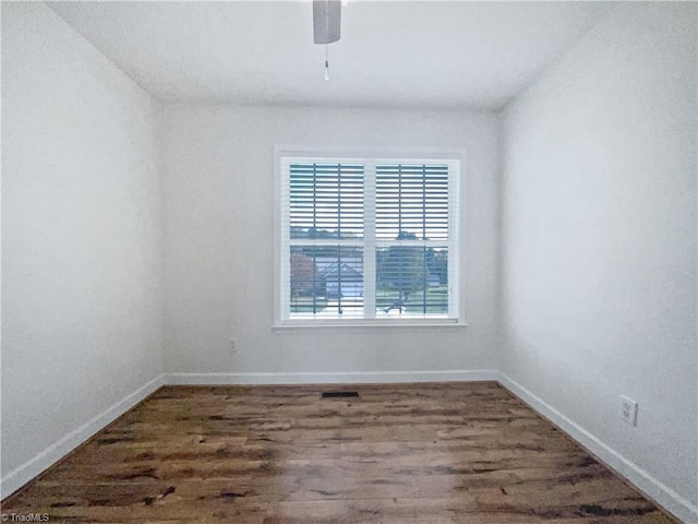 empty room featuring ceiling fan and dark hardwood / wood-style floors