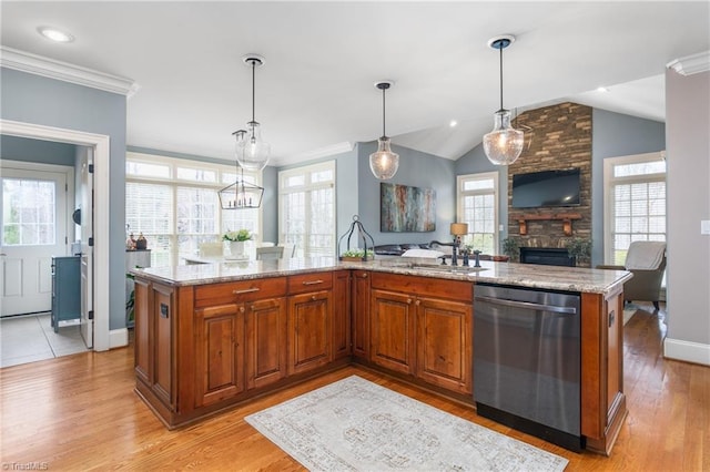 kitchen with a sink, brown cabinets, stainless steel dishwasher, and light stone counters