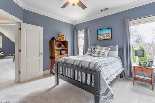 bedroom with visible vents, light colored carpet, ceiling fan, and crown molding