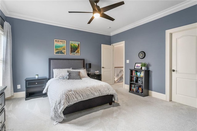 carpeted bedroom with ceiling fan, baseboards, and ornamental molding