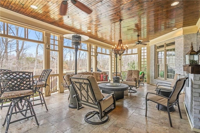 sunroom / solarium featuring wood ceiling and ceiling fan