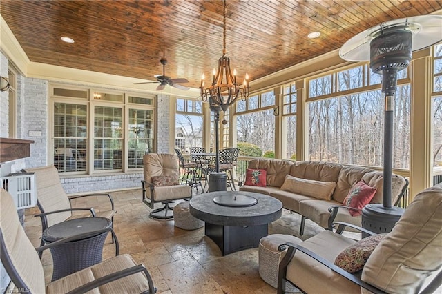 sunroom featuring an inviting chandelier and wood ceiling