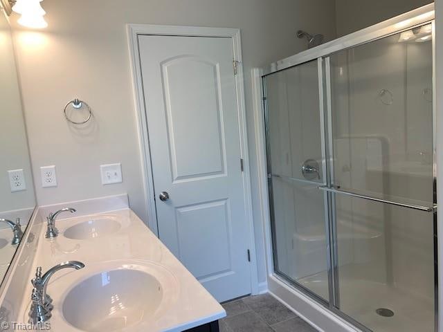 bathroom with an enclosed shower and vanity