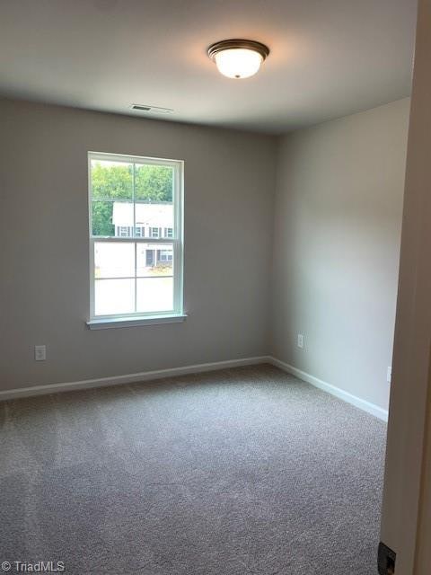 unfurnished room featuring carpet