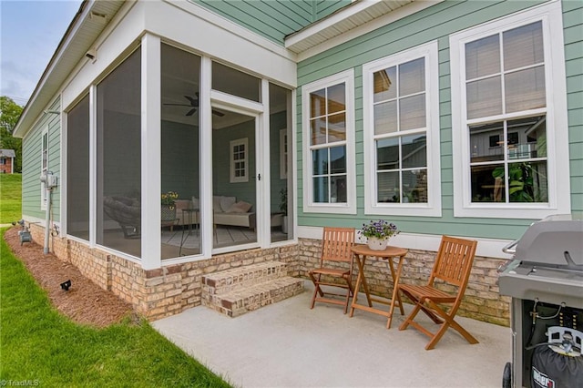 view of patio / terrace featuring a sunroom and area for grilling