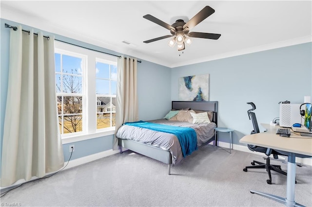 carpeted bedroom with multiple windows, baseboards, and ornamental molding