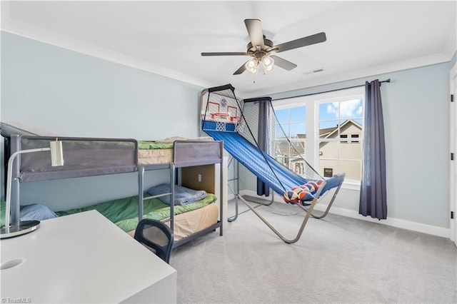 carpeted bedroom featuring a ceiling fan, baseboards, crown molding, and visible vents
