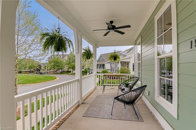 balcony with ceiling fan, a residential view, and covered porch