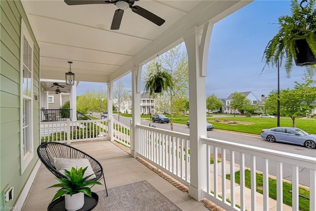 view of patio / terrace featuring a residential view, a ceiling fan, and a porch